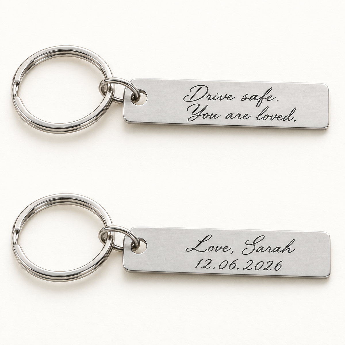 Illustrative front and back views of one silver bar keyring with example two-sided engraving