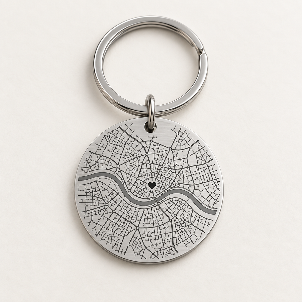 Silver personalised map keyring with an illustrative engraved street map and heart marker